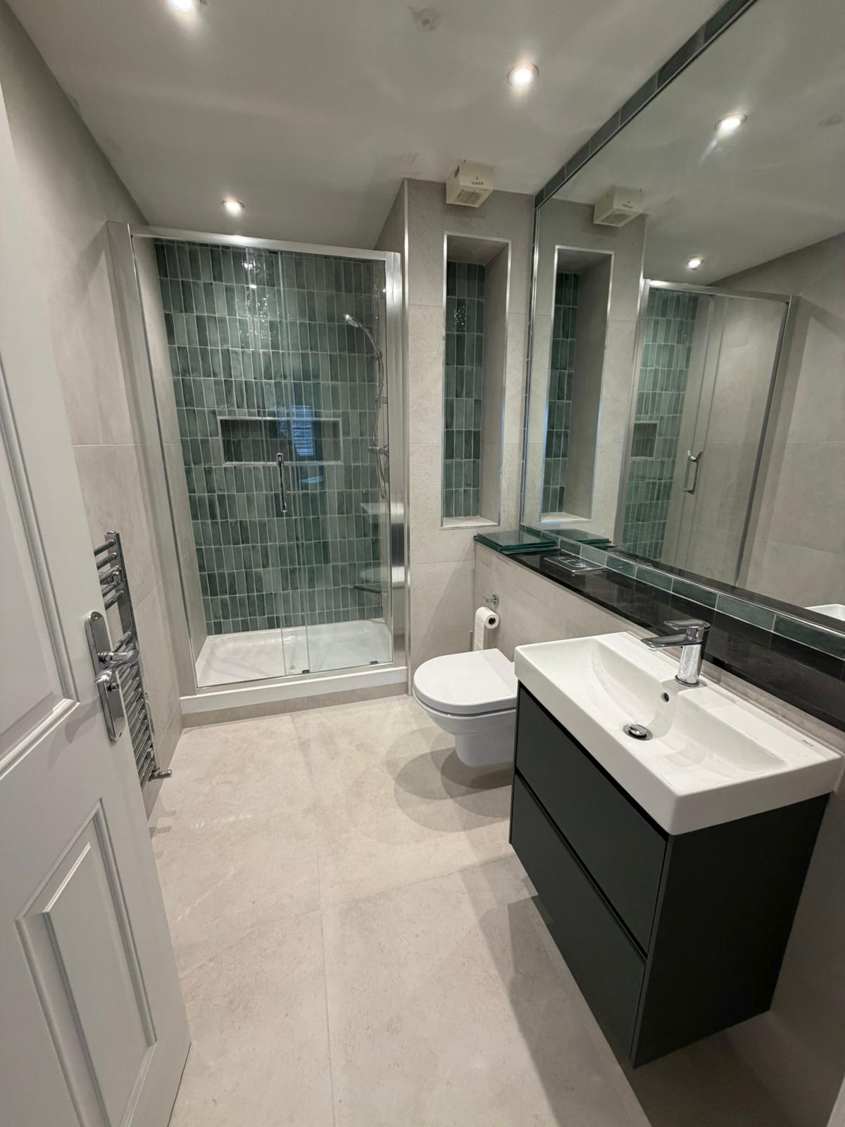 Modern bathroom with teal tiled shower